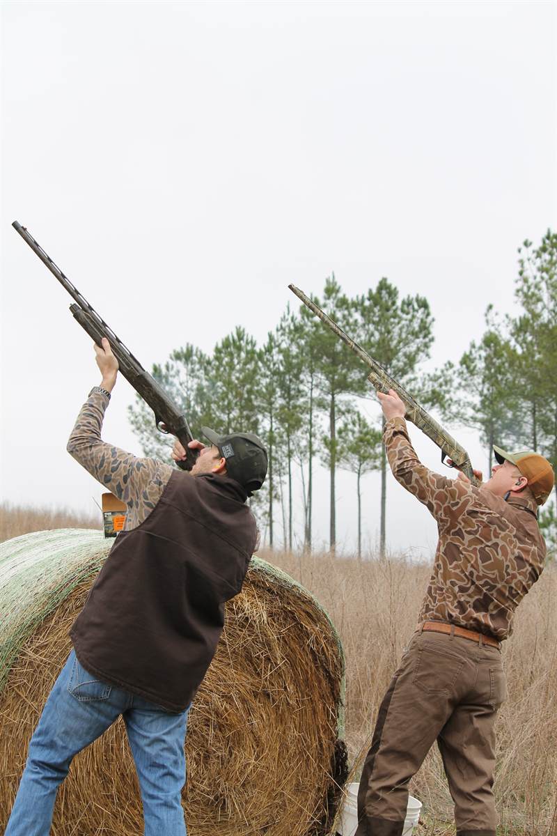 Two guns firing into low cloud on a foggy February morning